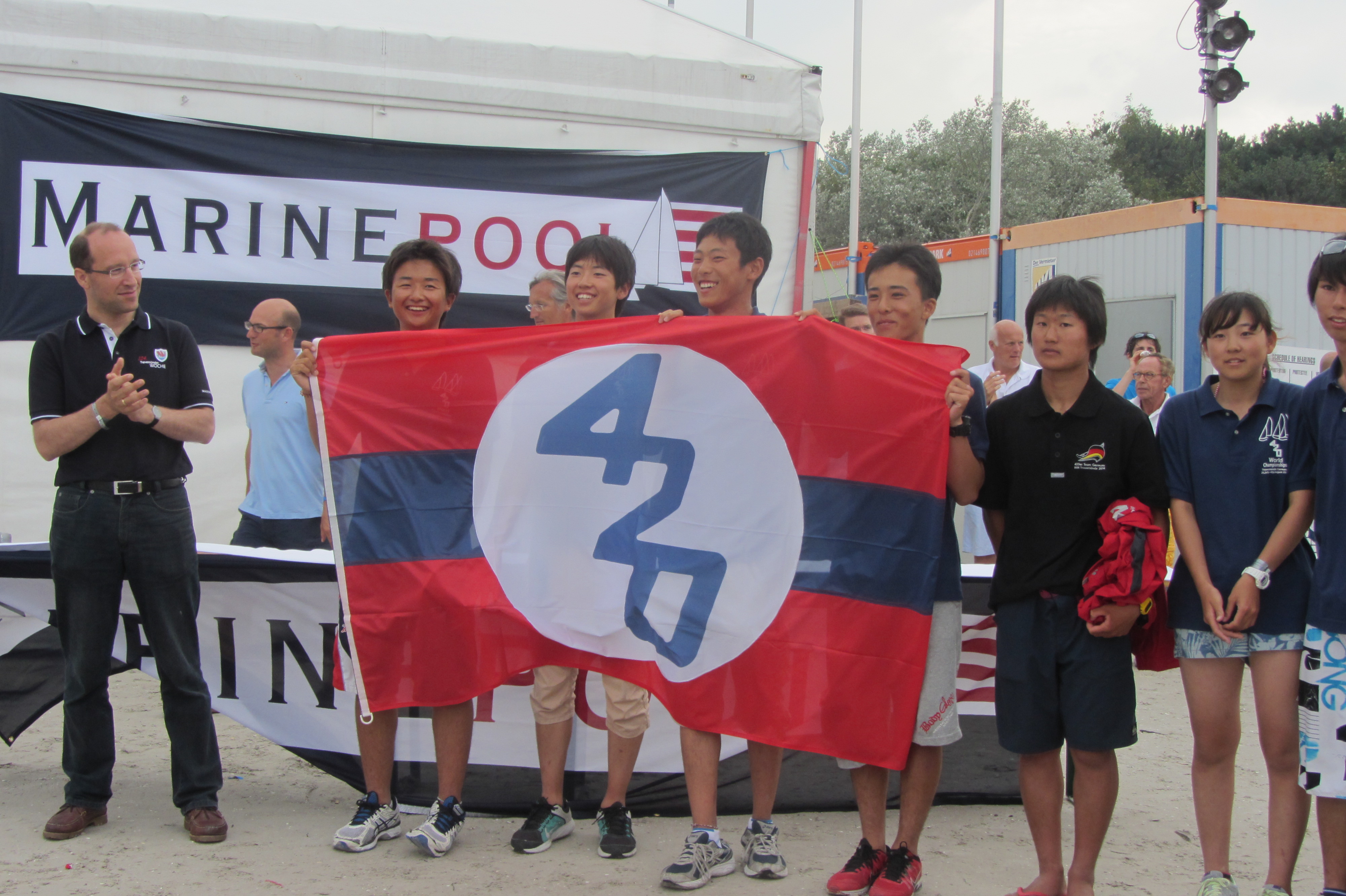 Germany hands over the International 420 Class Association flag to Japan for the 2015 Worlds
